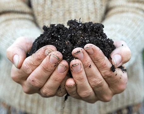 A man holding compost